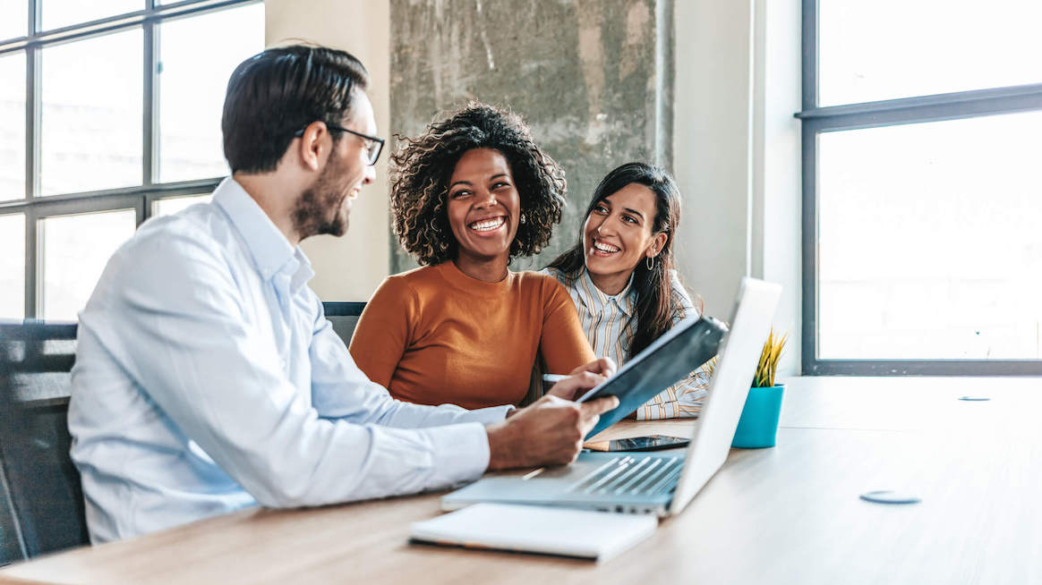 employee-coaching-team-laughing-talking-in-meeting